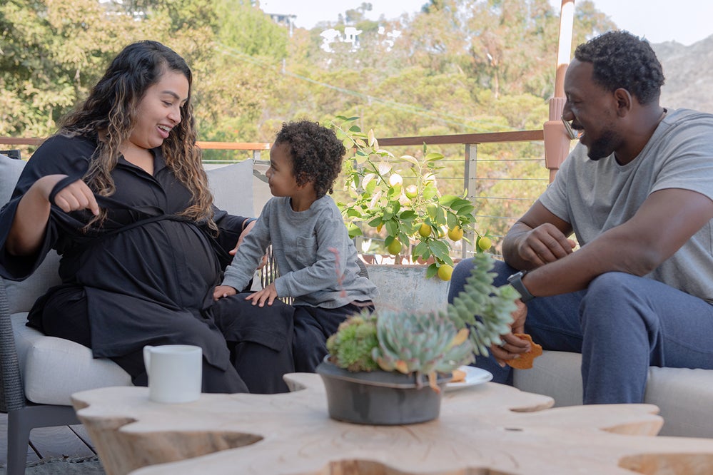 Pregnant woman outdoors with family wearing Everyday Lounge Set