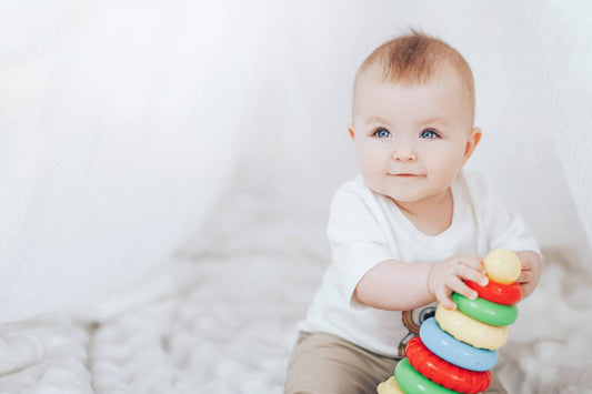 Baby playing with colorful stacking rings
