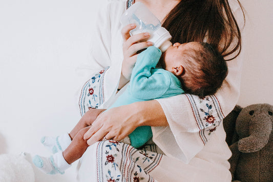 SNOO story - Sara Borden - woman bottle feeding infant