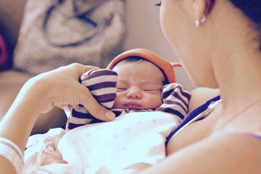 Mother cradles newborn baby