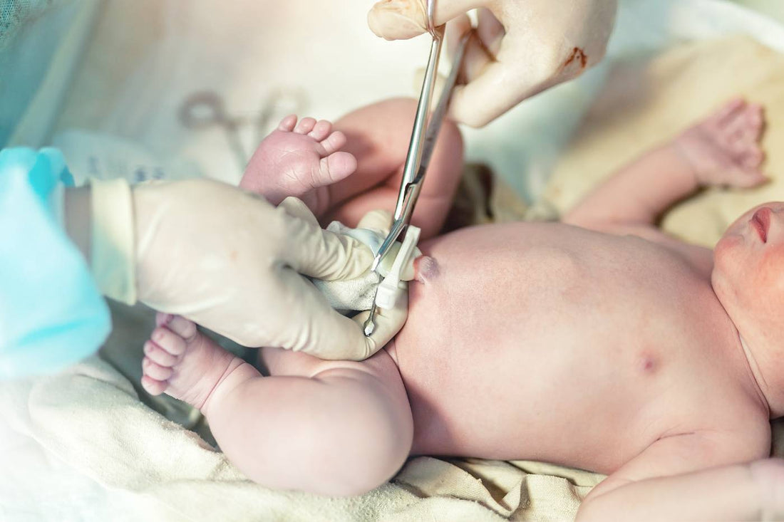 A doctor cuts a newborn's umbilical cord.