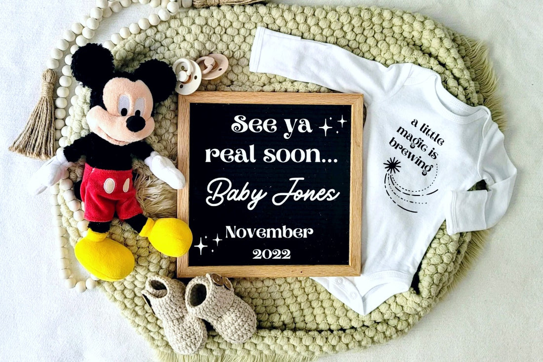Disney pregnancy announcement template from LovelyChaosPrints with a letterboard, Mickey Mouse doll, and onesie that says "a little magic is brewing"