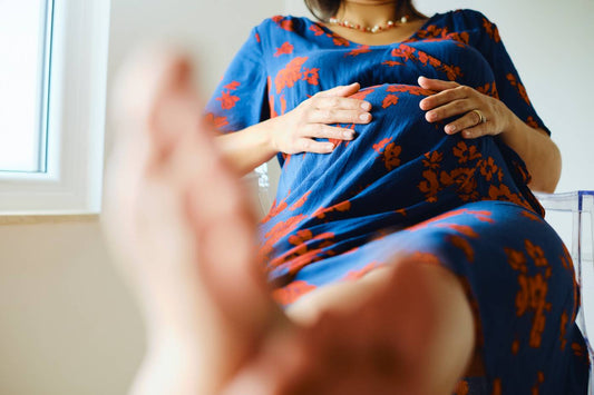 pregnant woman elevating feet because of pregnancy swelling
