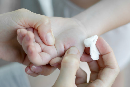 Removing a splinter from a toddler's hand