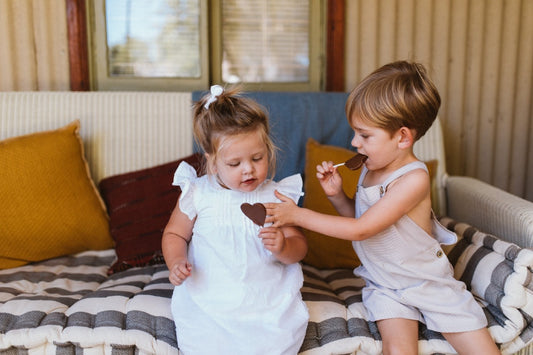 How to teach gratitude: Two siblings sharing a heart-shaped treat