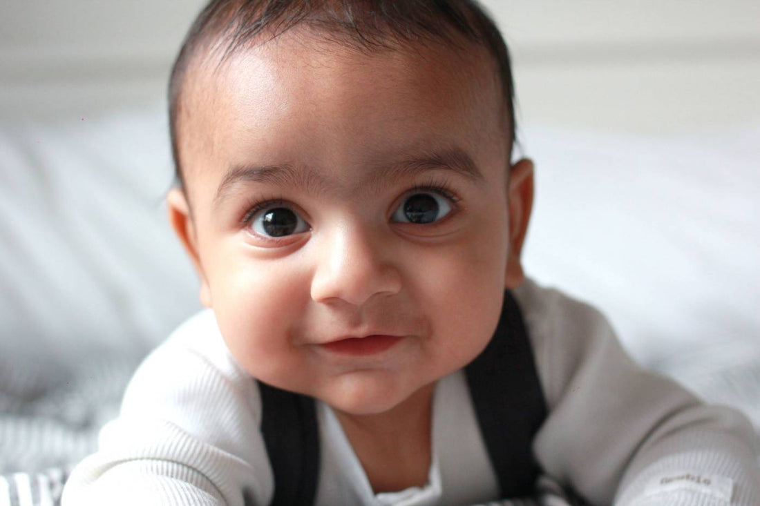 A cute baby stares ahead.