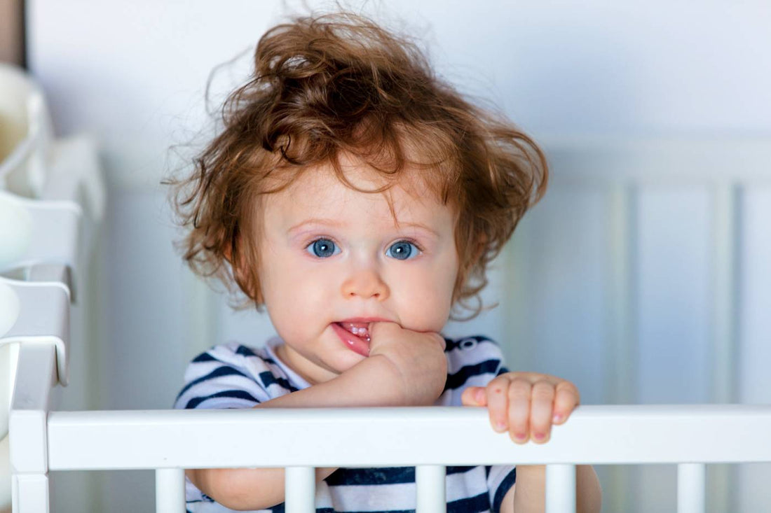 Toddler in cot experiencing 18-month sleep regression