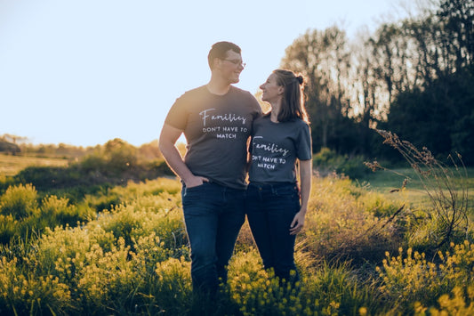 Couple wears shirts that read 'Families don't have to match' to announce adoption