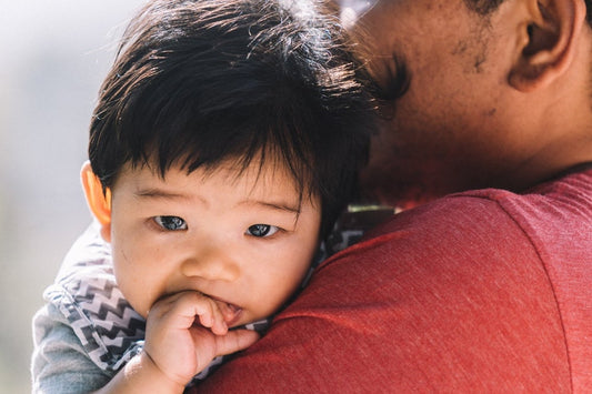Baby boy chews on his fingers