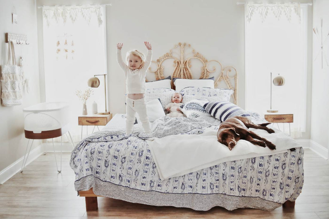 Pet benefits for kids - young kids playing on bed with dog