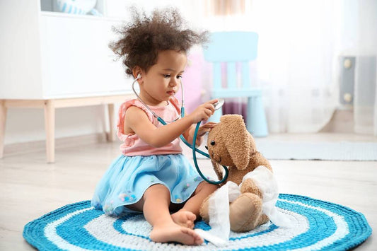 4-year-old playing doctor with stuffed animal toy