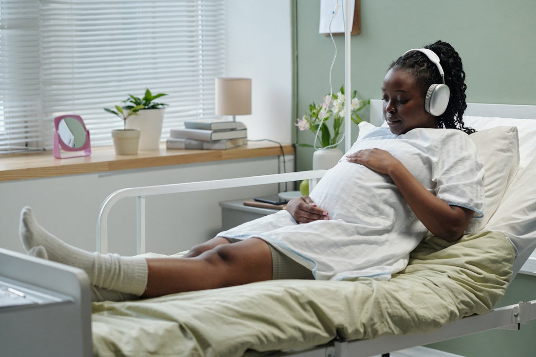 A mum listens to music on headphones during labor