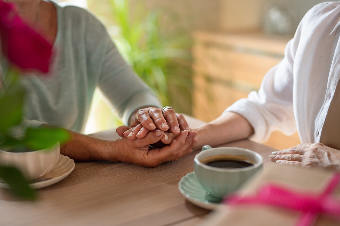 A woman comforts a friend coping with pregnancy loss