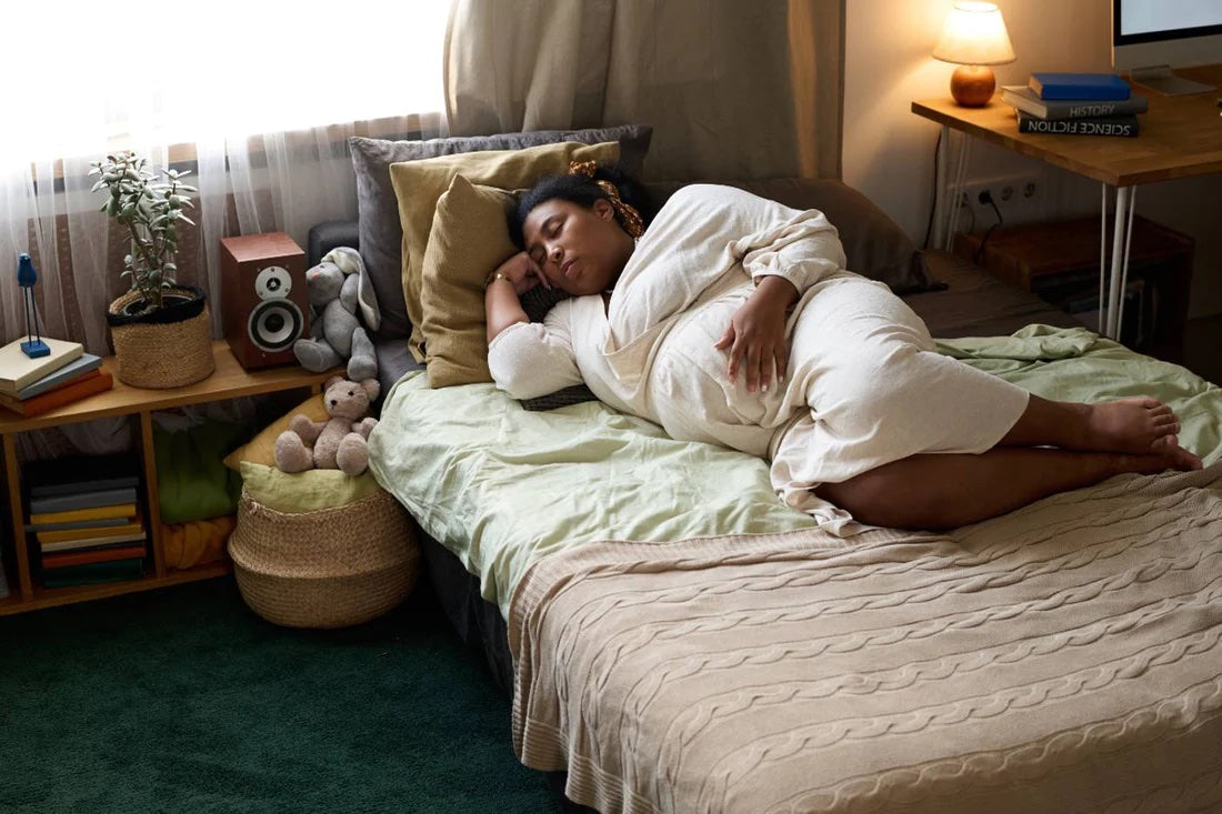 Tired pregnant woman lying in bed