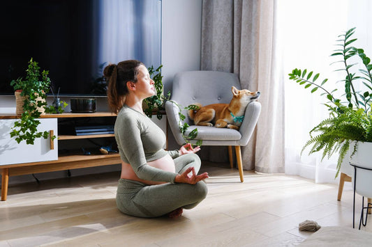 pregnant woman meditating on floor