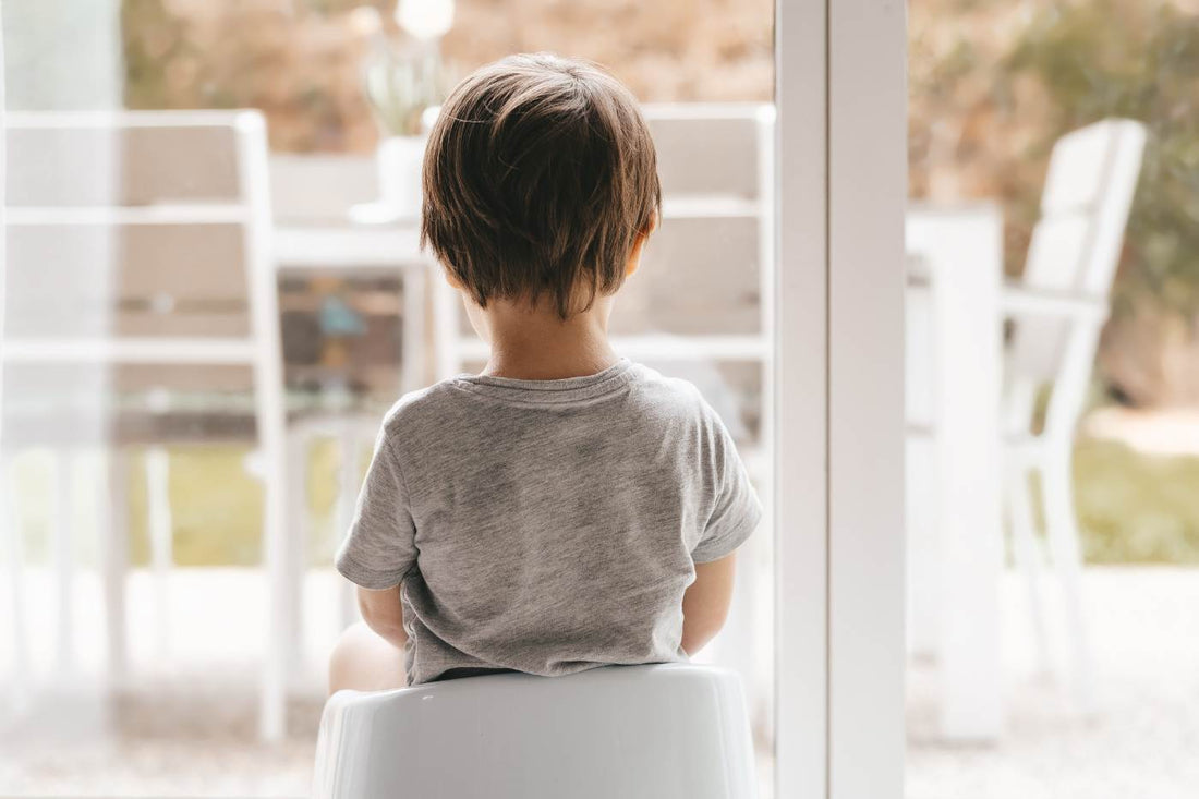 Toddler time-out tips - toddler seated in time-out looking out window