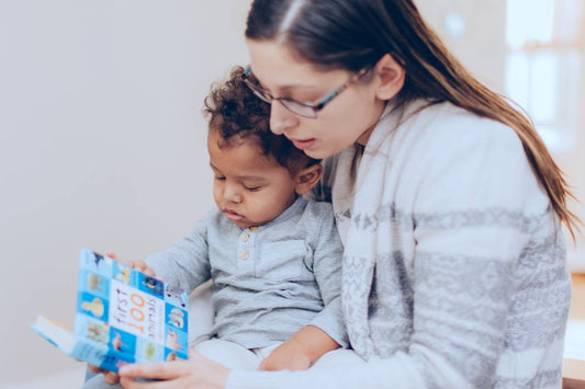 mum reading book to her baby