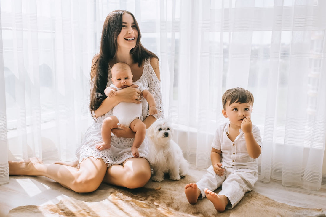 A mum with a baby and young toddler